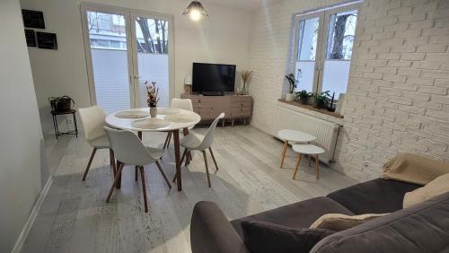a living room with a white table and chairs at PRADA Apartament Konin in Konin