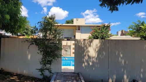a house with a fence and a swimming pool at Apart Costanera II in Posadas