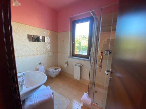 a bathroom with a shower and a sink and a toilet at Charming apartment with dreamy terrace in Arzachena