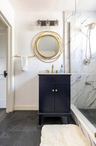 a bathroom with a black vanity and a mirror at Party House Heaven in North Hollywood