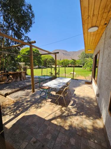 a picnic table and a bench on a patio at La Estancia del Molle in El Molle