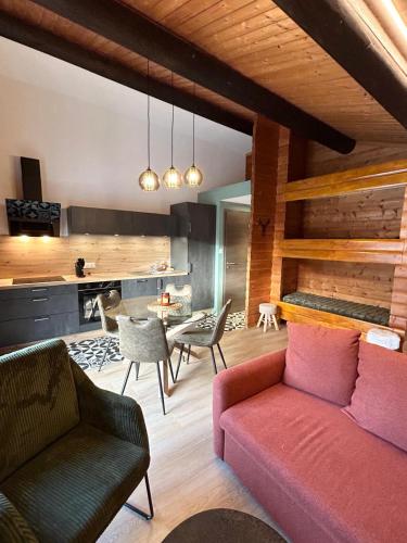 un salon avec un canapé et des chaises dans l'établissement Appartement meublé T2 le G de Gérardmer, à Gérardmer