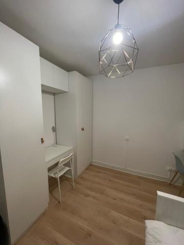 an empty room with a desk and a lamp at L'étincelant, Centré - Connecté - Lumineux & Cosy in Nancy
