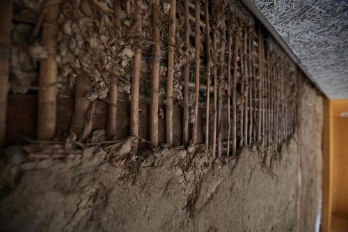 a wall with a bunch of pipes on it at TSUCHIYA Kinosaki onsen in Toyooka