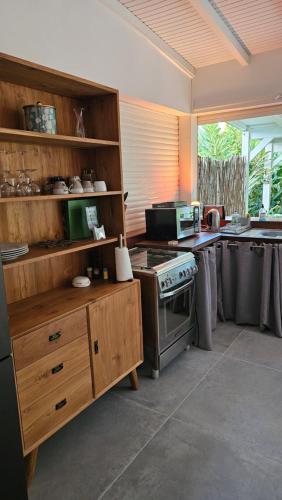 a kitchen with a stove and a counter top at Habitation Villa Les Cassias in Petit-Bourg