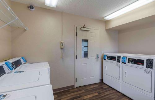 a room with two washing machines and a door at Extended Stay America Suites - Dallas - Plano Parkway in Plano