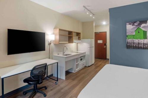 a room with a bed and a desk and a sink at Extended Stay America Premier Suites - Asheville in Asheville