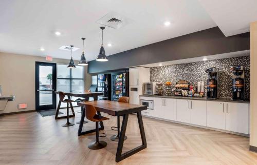 a kitchen with a table and two stools at Extended Stay America Premier Suites - Pensacola - NAS Corry Station in Pensacola