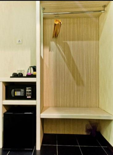 a kitchen with a shower with a microwave in it at Venus Boutique Hotel in Melaka