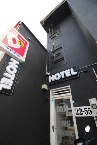 a hotel sign on the side of a black building at DAM Hotel Pereira in Pereira
