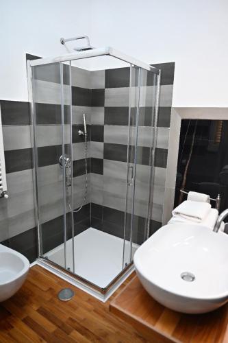 a bathroom with a glass shower and a sink at B&B MareLuna in Angri