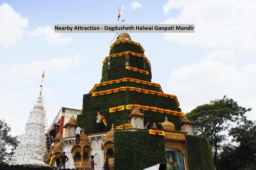 a pagoda in front of a building at Super Hotel O River View Near Shaniwar Wada in Pune