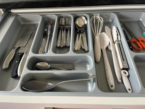 a tray filled with utensils in a drawer at Spacious Retreat near Ferry & Mall in Wellington