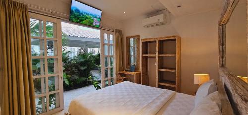 Ένα ή περισσότερα κρεβάτια σε δωμάτιο στο Central Canggu Guesthouse