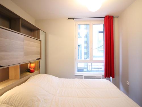 une chambre avec un lit et une fenêtre dans l'établissement Bel F3 en hyper centre du Mont Dore, 50m des Thermes, 7 couchages, tout équipé, classé 2 étoiles - FR-1-415-14, à Le Mont-Dore
