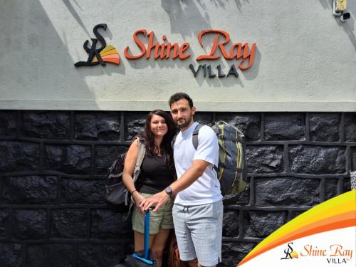 a man and a woman standing in front of a building at Shine Ray VILLA in Galle