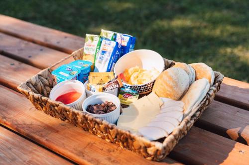 a basket filled with different types of food on a picnic table at Puerta austral in Puelo