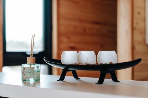 a tray with four coffee cups on a table at Puerta austral in Puelo