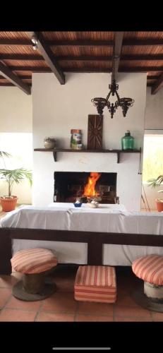 a fireplace in a living room with a fire place at Guesthouse Entre Campo y Mar in La Coronilla