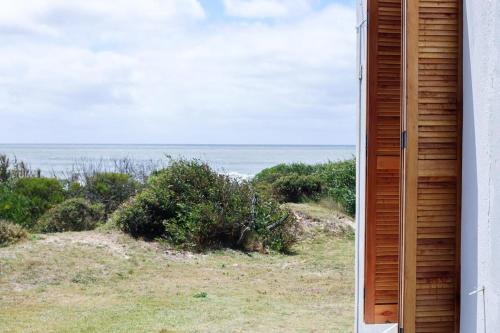 a window view of the ocean from a house at Guesthouse Entre Campo y Mar in La Coronilla