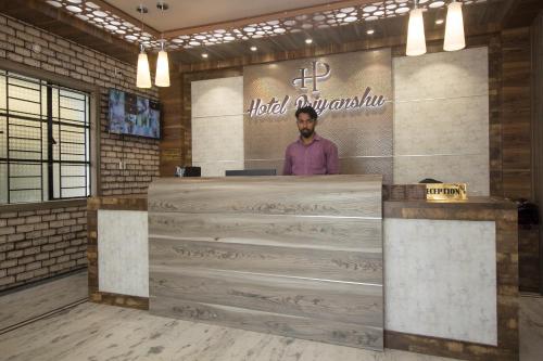 a man standing behind a counter in a room at Super Capital O Priyanshu in Siliguri