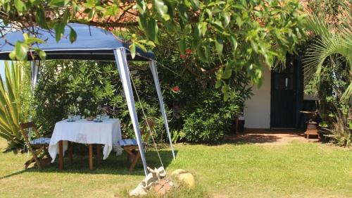 a gazebo with a table in a yard at Guesthouse Entre Campo y Mar in La Coronilla