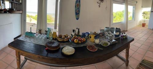 a table with bowls of food on it in a kitchen at Guesthouse Entre Campo y Mar in La Coronilla