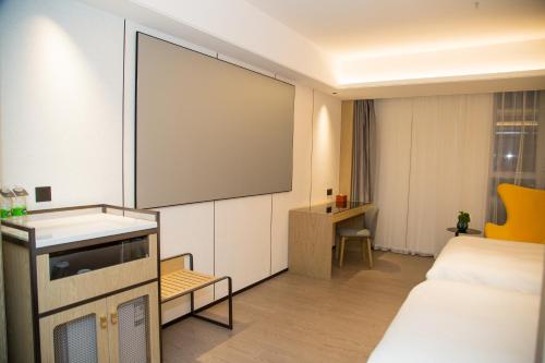Postel nebo postele na pokoji v ubytování 柏高雅酒店江门新会时代城店 pacoHotel