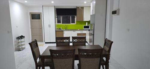 a kitchen with a dining room table and chairs at 77 Fulaga Flats in Suva
