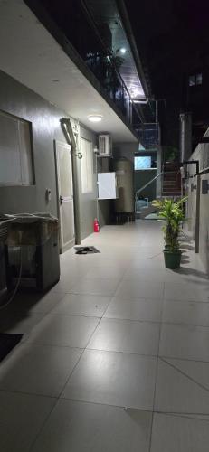 an empty room with plants on the floor at 77 Fulaga Flats in Suva