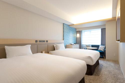 Postel nebo postele na pokoji v ubytování Hotel Emion Sapporo