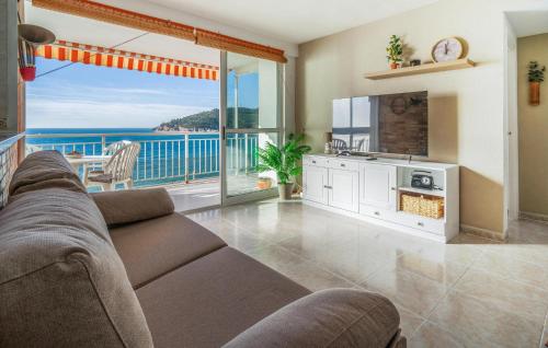a living room with a couch and a view of the ocean at Nice Apartment In Oropesa Del Mar in Oropesa del Mar