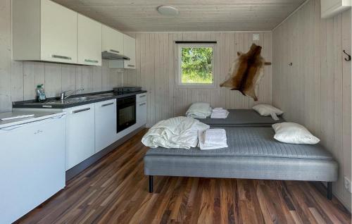 a room with two beds in a kitchen with a sink at Gorgeous Home In Laholm With Wifi in Laholm