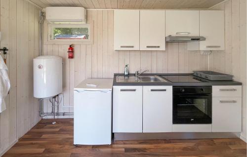 a kitchen with white cabinets and a sink at Stunning Home In Laholm With Wifi in Laholm