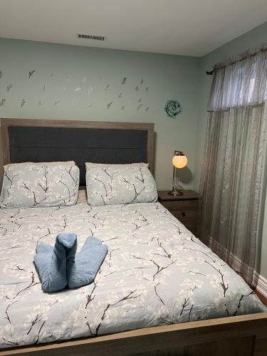 a bedroom with a bed with a blue pillow on it at Entire Basement Apartment in Toronto