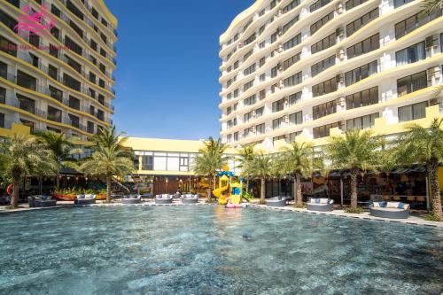 a pool in the middle of a hotel with a playground at Lux Resort Apartment/2BR/Private Beach/Pools in Hà My Tây (2)
