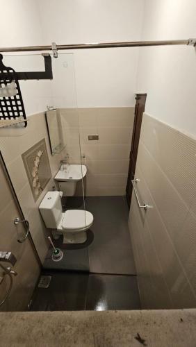 a bathroom with a toilet and a sink at Kandy home in Kandy