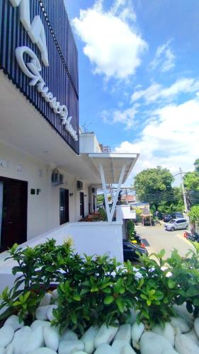 a building with a sign on the side of it at Puri Rama Guest House Denpasar Bali in Kerobokan