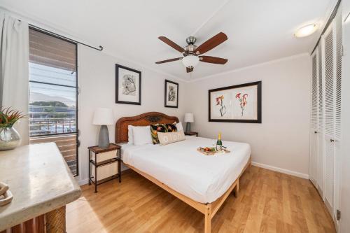 a bedroom with a bed and a ceiling fan at Paki Maui 217 · PM 217 Cozy 1BR Oceanfront Condo w Pool in Lahaina