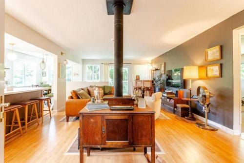 a large living room with a wood stove in it at Evergreen Escape in Felton