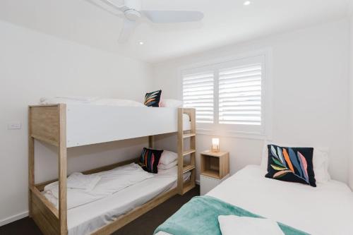 two bunk beds in a room with a window at 46 Banjo Patterson Crescent in Jindabyne