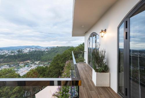 a balcony with a view of a city at Đá Góc Nhà Boutique Hotel in Da Lat