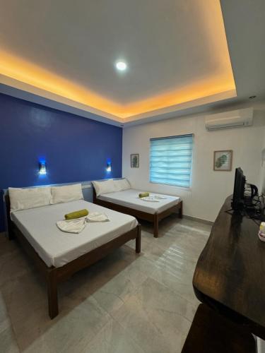 a living room with two beds and a couch at GreenEscape Beach Resort in Puerto Galera