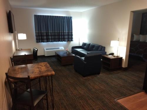 a living room with a couch and a table at Super 8 by Wyndham Bemidji MN in Bemidji