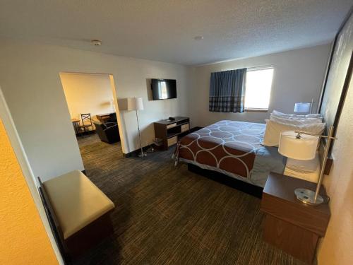 a large hotel room with a bed and a desk at Super 8 by Wyndham Bemidji MN in Bemidji