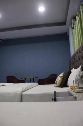 two beds sitting next to each other in a room at Darjeeling Homes The Grace in Darjeeling