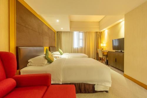 a hotel room with a large bed and a red couch at Aurum International Hotel Xi'an in Xi'an