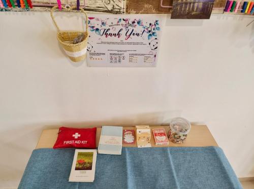 a table with books and a sign on a wall at Encorp Strand Suite by Luvit Stay in Petaling Jaya