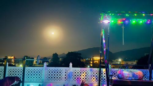 a white fence with a light on it at night at Hotel White House - A Family Homestay in Pushkar