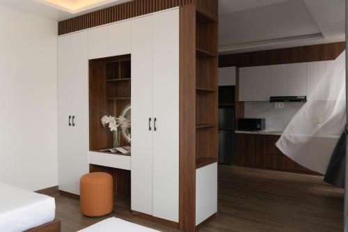 a room with a sliding door leading into a kitchen at Anteaus Hotel Đà Lạt in Da Thien
